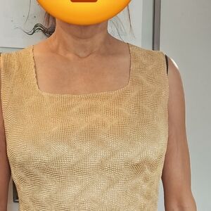 Gold sleeveless top.